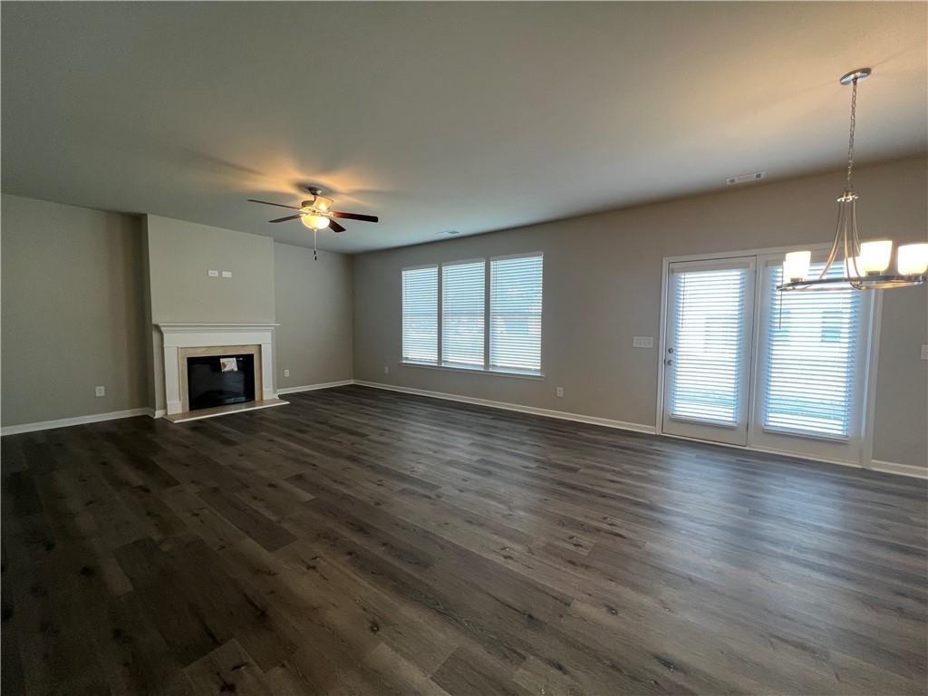213 Cornwell Way Calhoun, GA 30701 - Photo 3 of 18 a view of an empty room with wooden floor fireplace and a window