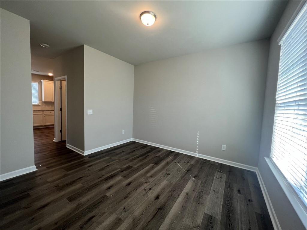 213 Cornwell Way Calhoun, GA 30701 - Photo 5 of 18 an empty room with wooden floor and windows