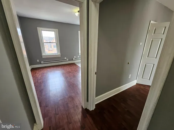 a bathroom with a tub a sink and mirror