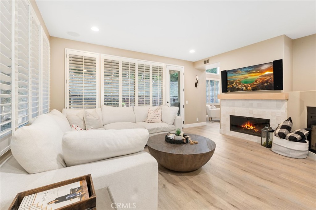 48 Creek View Road Coto de Caza, CA 92679 - Photo 11 of 39 a living room with furniture a fireplace and a flat screen tv