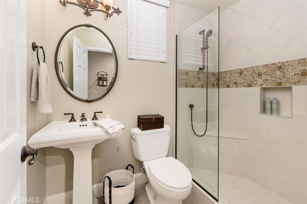 48 Creek View Road Coto de Caza, CA 92679 - Photo 15 of 39 a bathroom with a toilet sink and mirror