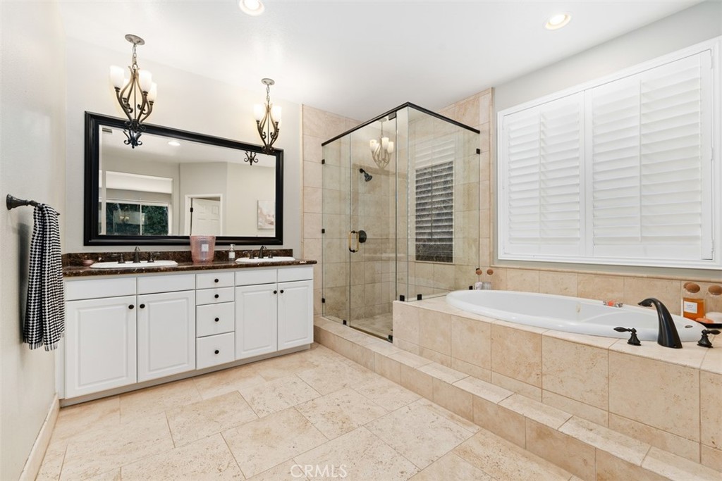 48 Creek View Road Coto de Caza, CA 92679 - Photo 20 of 39 a spacious bathroom with a bathtub sink and mirror