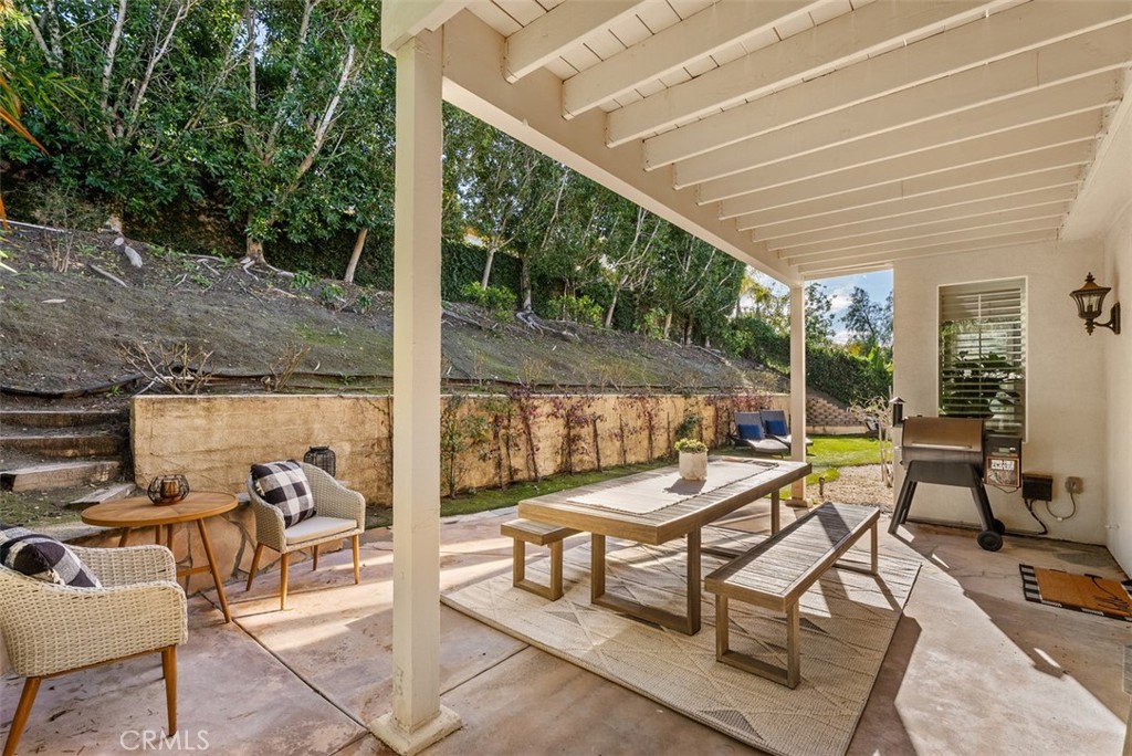 48 Creek View Road Coto de Caza, CA 92679 - Photo 27 of 39 a view of a patio with a dining table and chairs next to a yard