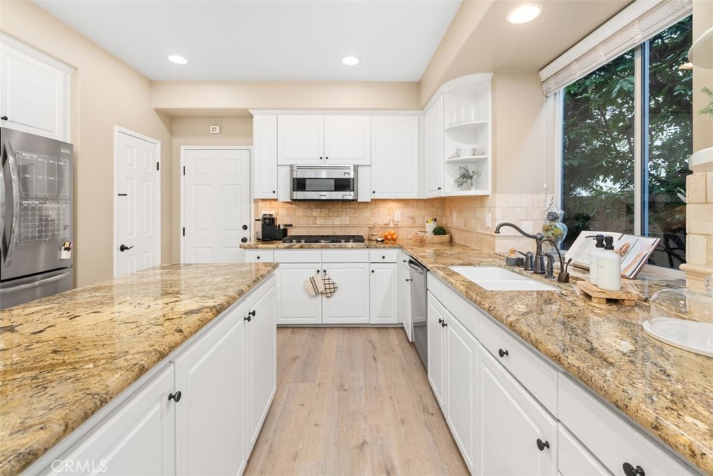 48 Creek View Road Coto de Caza, CA 92679 - Photo 9 of 39 a large kitchen with stainless steel appliances granite countertop a sink stove and refrigerator