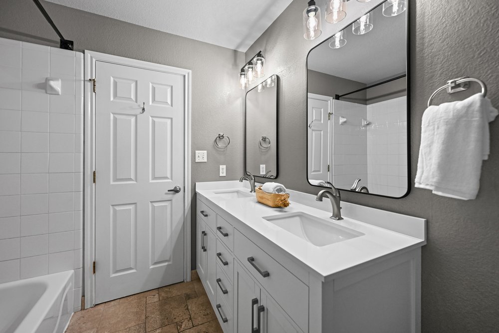 2823 Lantana Ridge Drive Austin, TX 78732 - Photo 24 of 34 a bathroom with a sink double vanity and a mirror