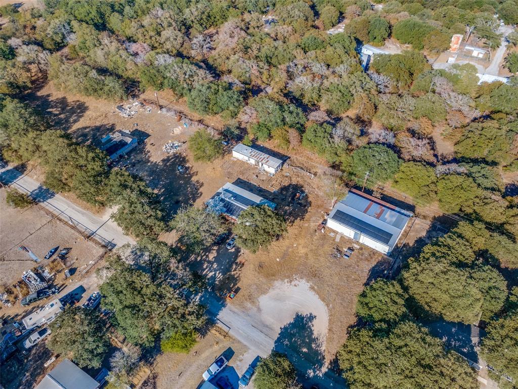 an aerial view of a house with a yard and lake view