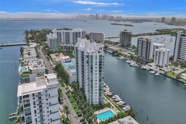 a dining room with kitchen island furniture a chandelier and kitchen view