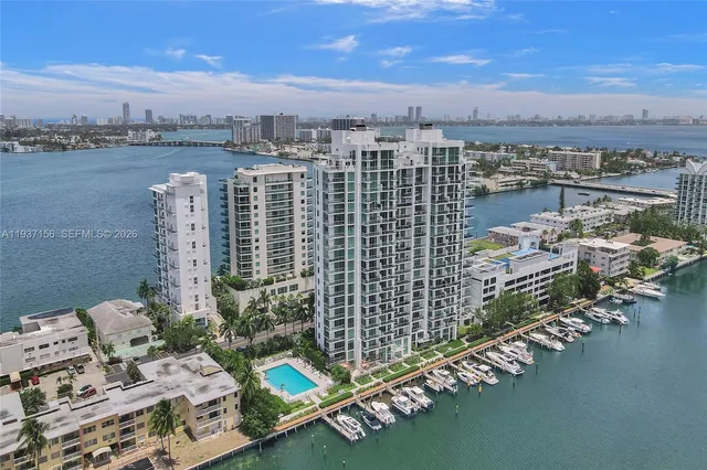 a kitchen with stainless steel appliances kitchen island granite countertop a refrigerator and a stove top oven