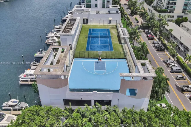 a kitchen with a stove a refrigerator and a view of living room