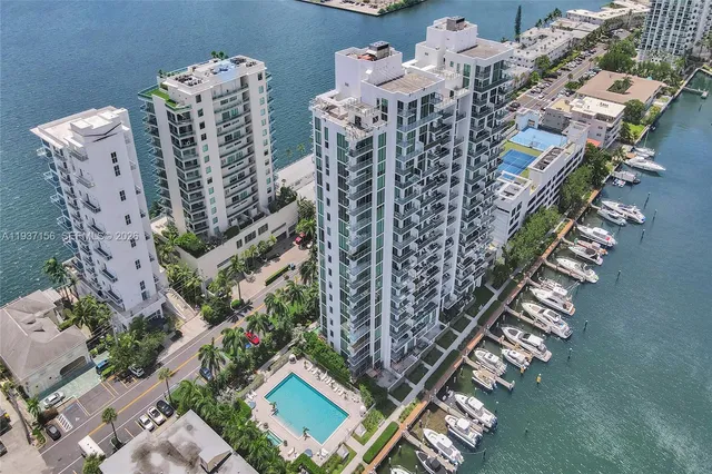 a living room with furniture kitchen view and a large window