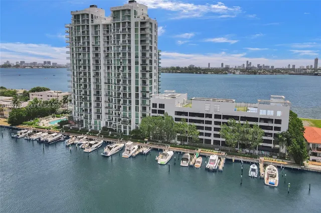 a living room with furniture kitchen view and a flat screen tv