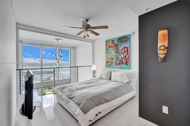 a bedroom with a bed and a flat tv screen