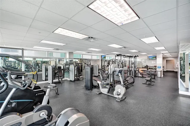 a view of a dining room with furniture and a kitchen