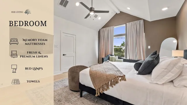 a bedroom with a bed lamp and a large window