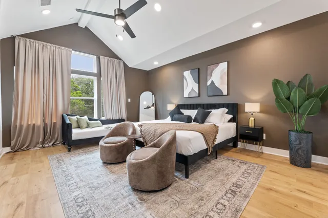 a spacious bedroom with a large bed and a couch