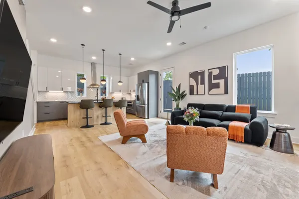 a living room with fireplace furniture and a flat screen tv