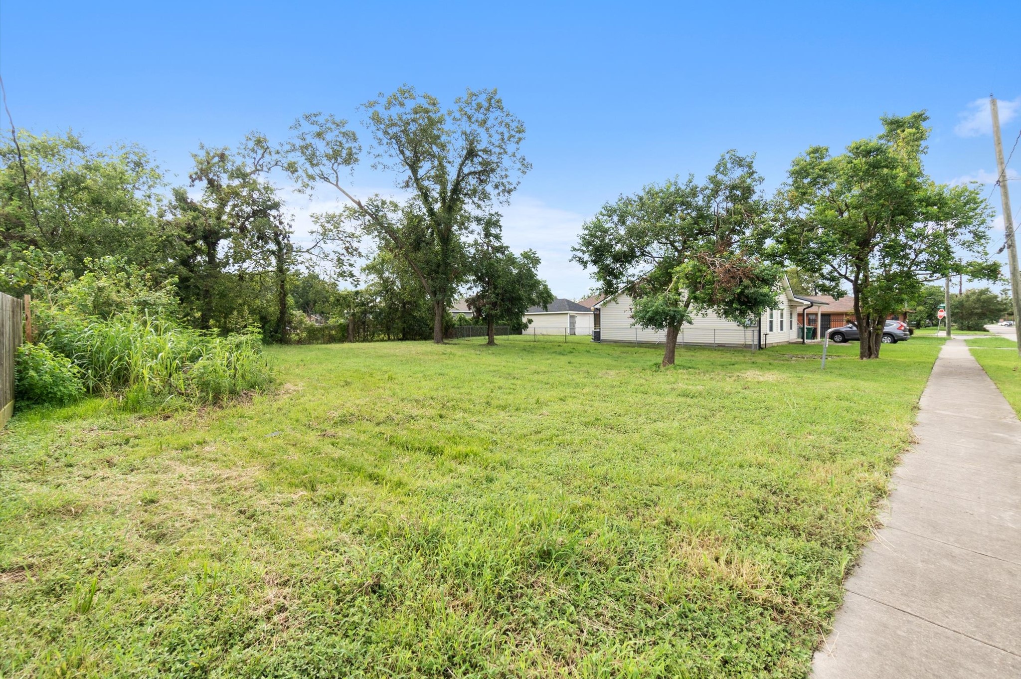 1711 Benson Street Houston, TX 77020 - Photo 5 of 11 a view of a grassy field with trees in the background