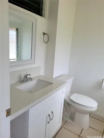 a white toilet sitting next to a bathroom sink