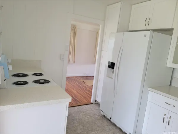 a view of a kitchen from the hallway