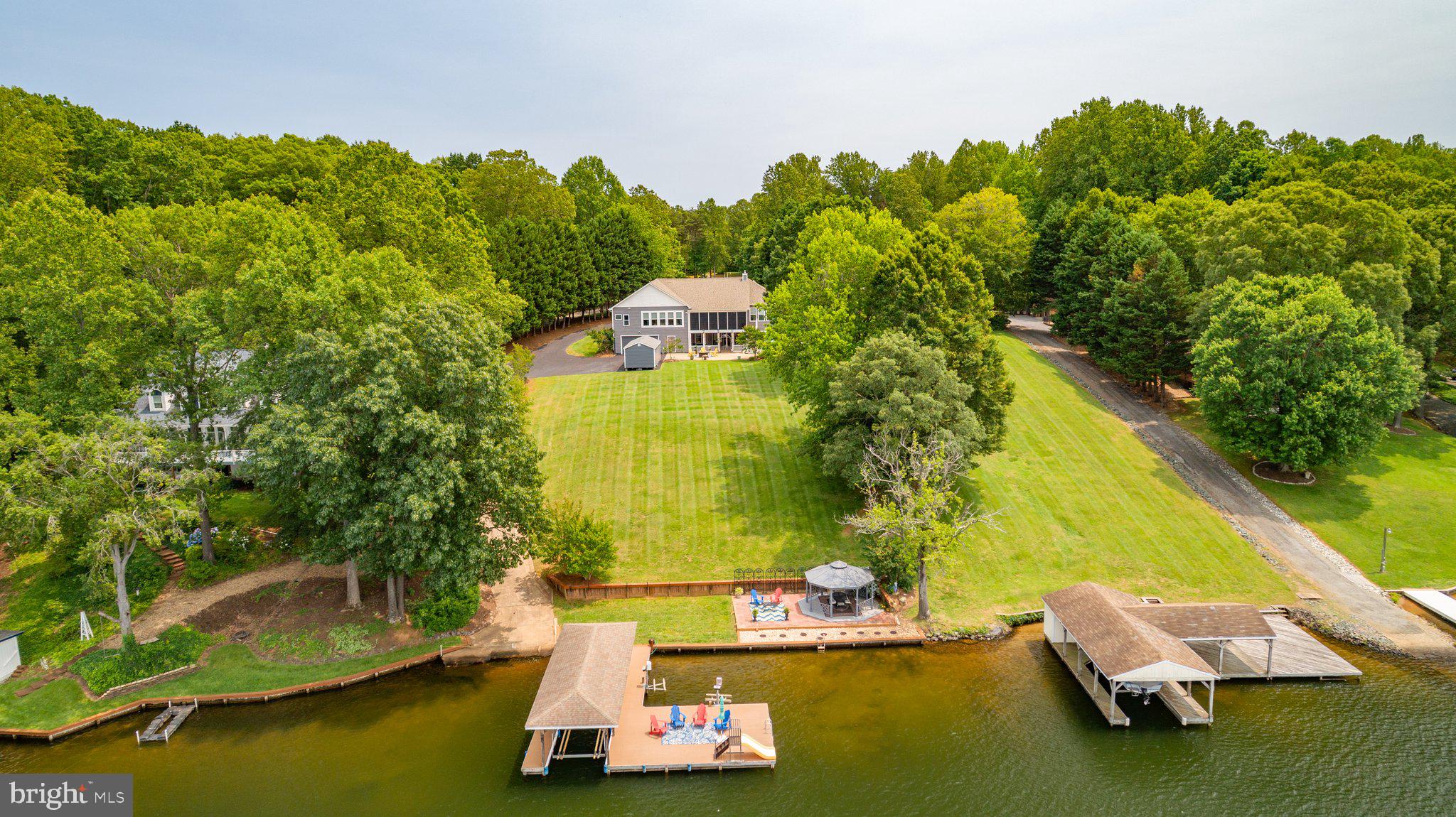 565 Busbees Point Road Bumpass, VA 23024 - Photo 1 of 135 Aerial view of back yard hang out area, boathouse