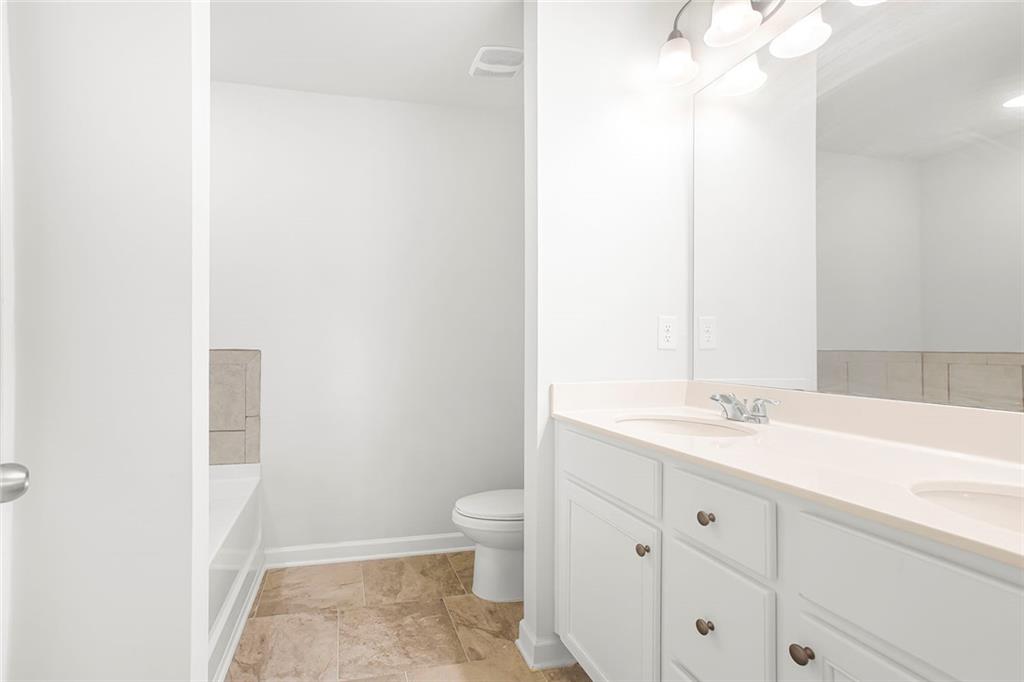 3570 Saratoga Circle Decatur, GA 30034 - Photo 17 of 26 a bathroom with a sink a toilet and vanity