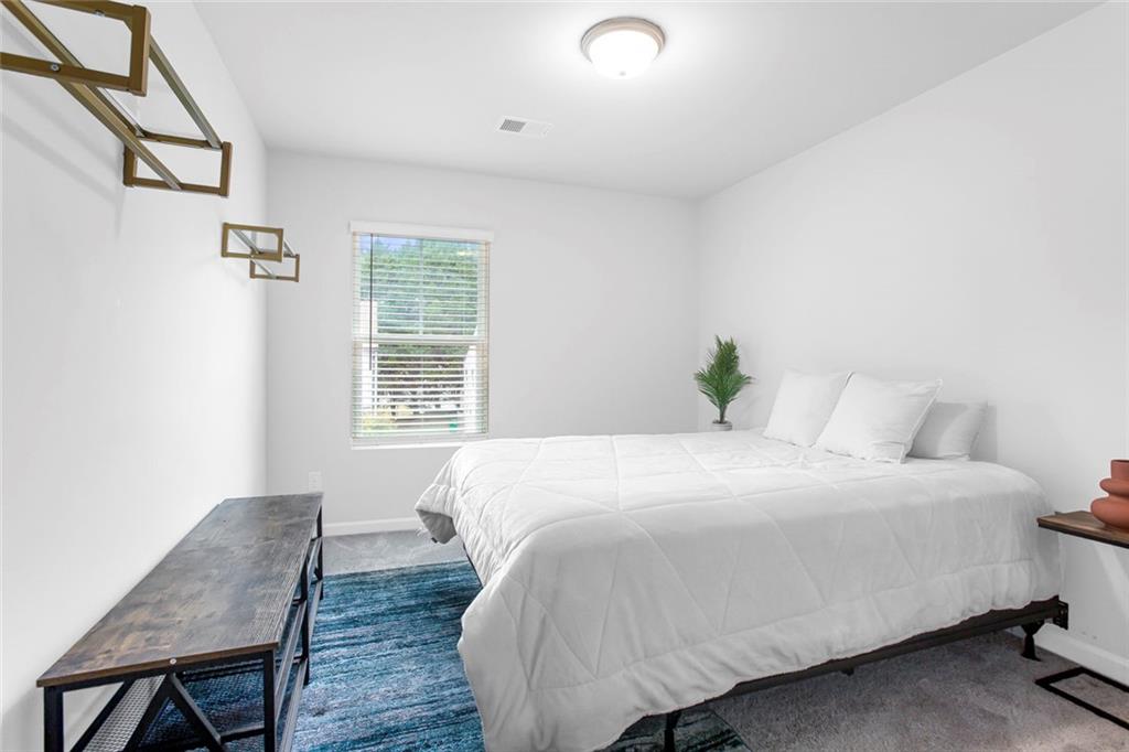 3570 Saratoga Circle Decatur, GA 30034 - Photo 21 of 26 a bedroom with a bed and wooden floor