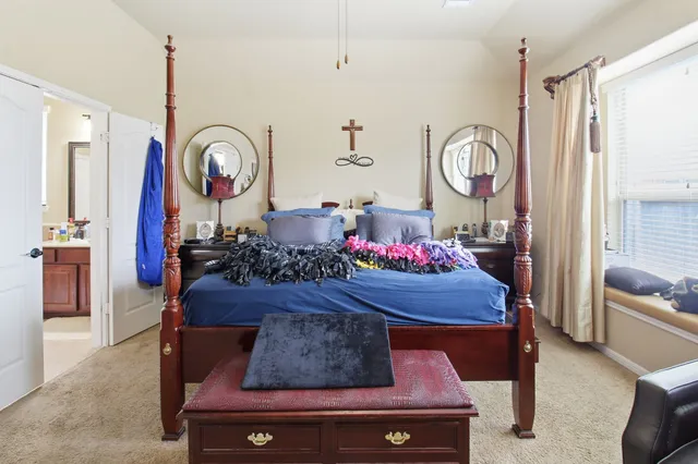 a bed room with furniture and a chandelier