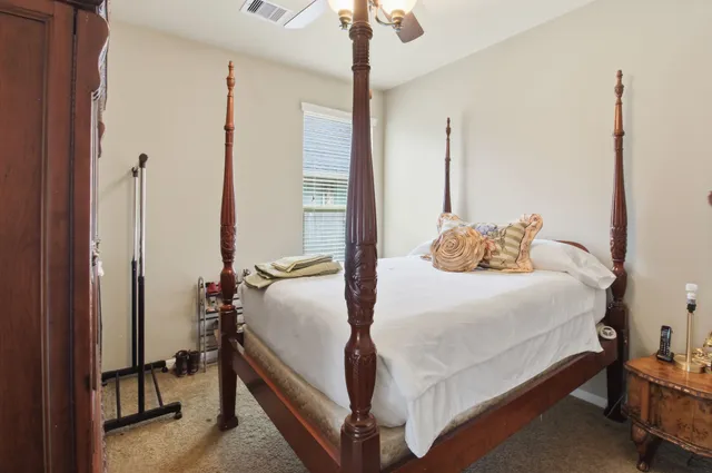 a bedroom with a bed and a chandelier