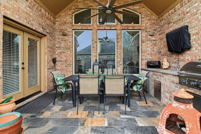 a view of a patio with table and chairs and potted plants