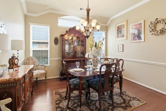 a view of a dining room with furniture and wooden floor
