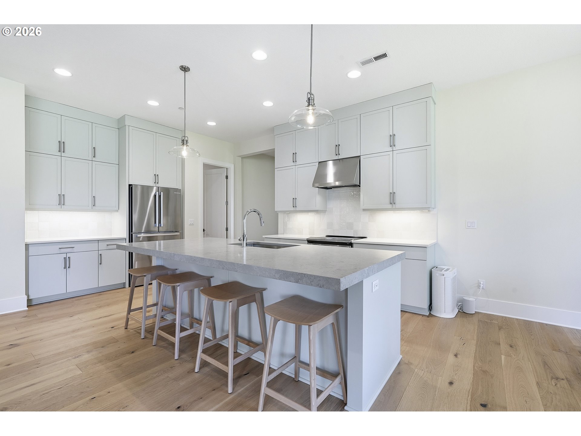 18771 Northwest Collins Road North Plains, OR 97133 - Photo 13 of 48 a kitchen with kitchen island white cabinets and stainless steel appliances