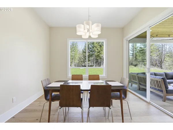 a view of a dining room with furniture wooden floor and a chandelier