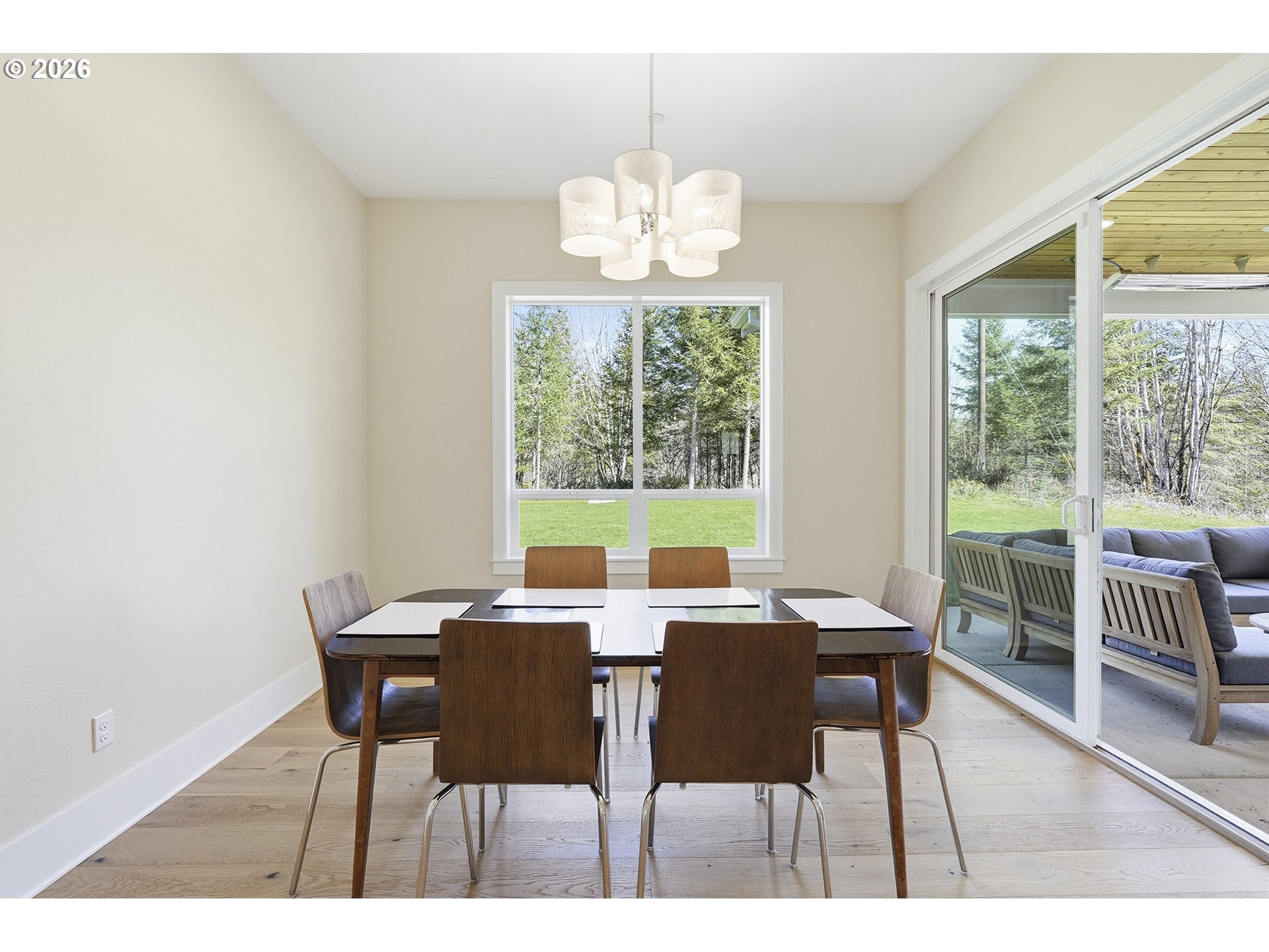 18771 Northwest Collins Road North Plains, OR 97133 - Photo 16 of 48 a view of a dining room with furniture wooden floor and a chandelier