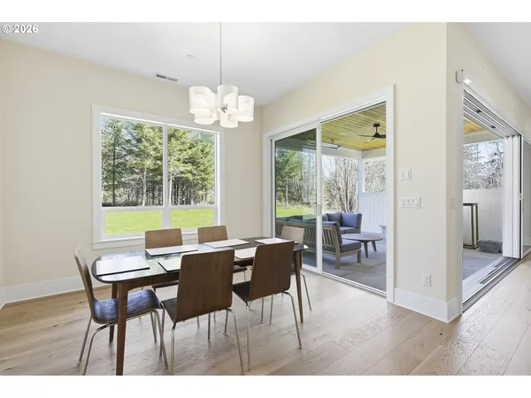 a view of a dining room with furniture wooden floor and chandelier