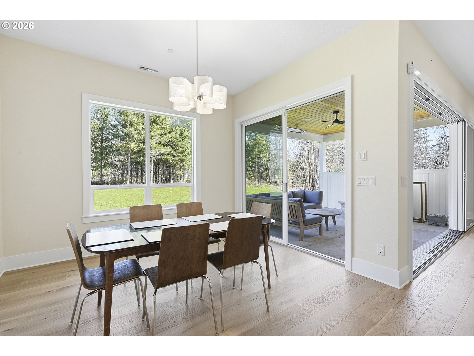 18771 Northwest Collins Road North Plains, OR 97133 - Photo 17 of 48 a view of a dining room with furniture wooden floor and chandelier