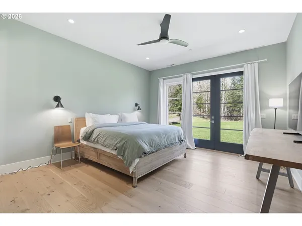 a bedroom with a large bed and a window