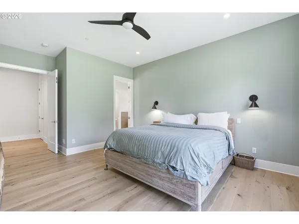 a bedroom with a bed and wooden floor