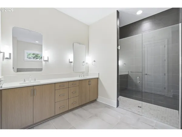 a bathroom with a shower sink and mirror