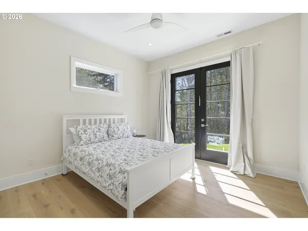 a bedroom with a bed and a picture of the wall