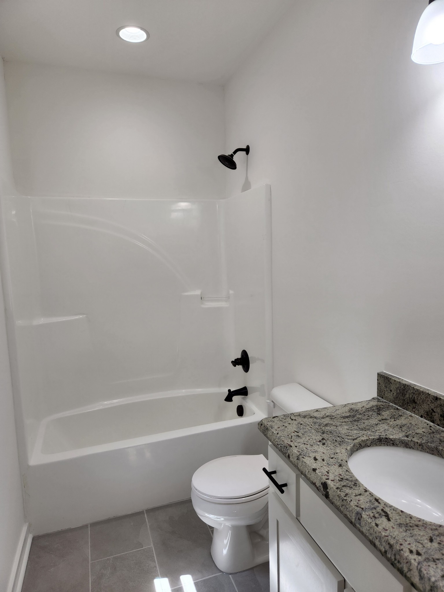 62 Shoulders Road Dixon Springs, TN 37057 - Photo 12 of 22 a bathroom with a granite countertop toilet a sink and a bathtub