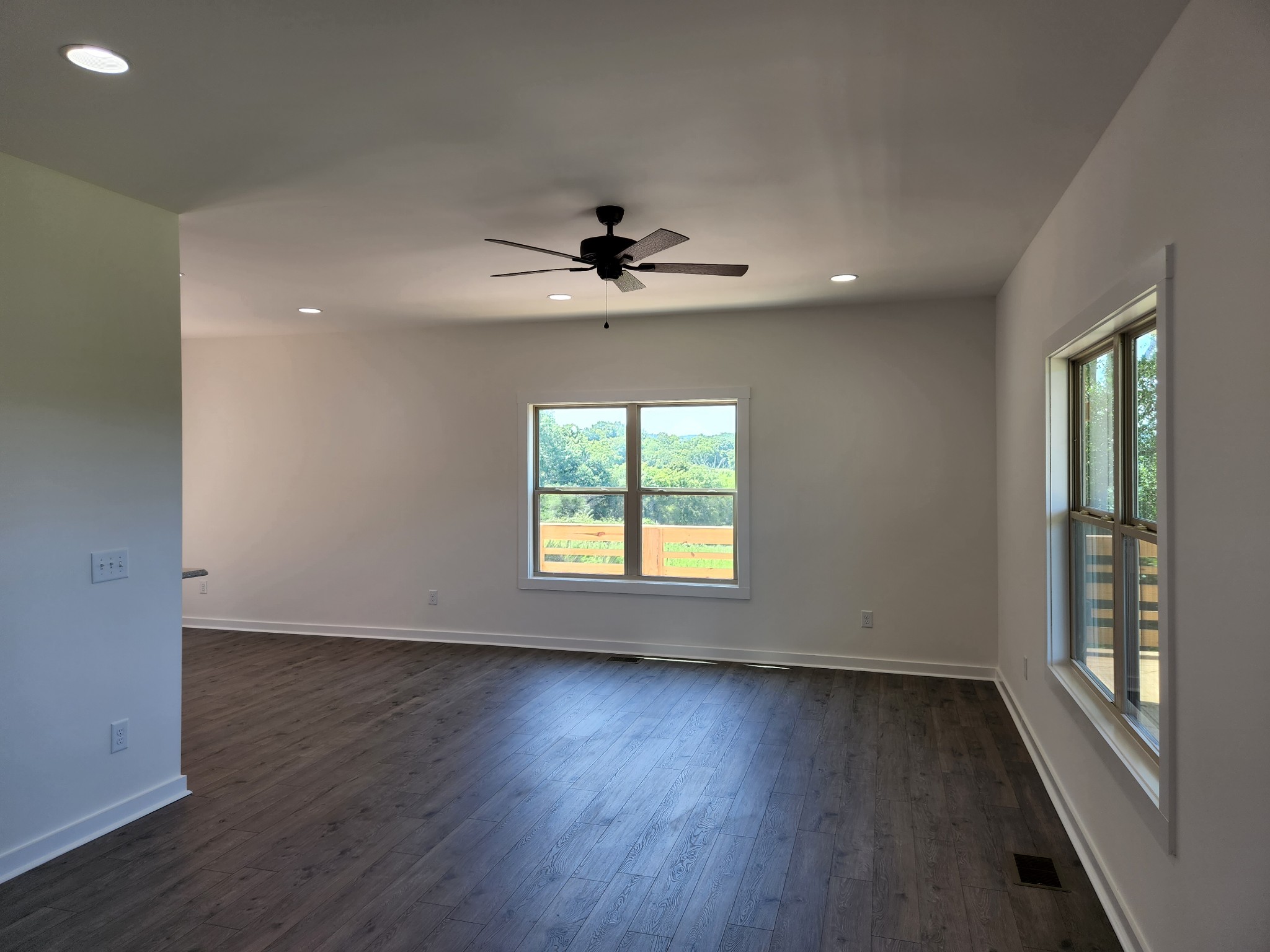 62 Shoulders Road Dixon Springs, TN 37057 - Photo 5 of 22 an empty room with wooden floor chandelier fan and windows