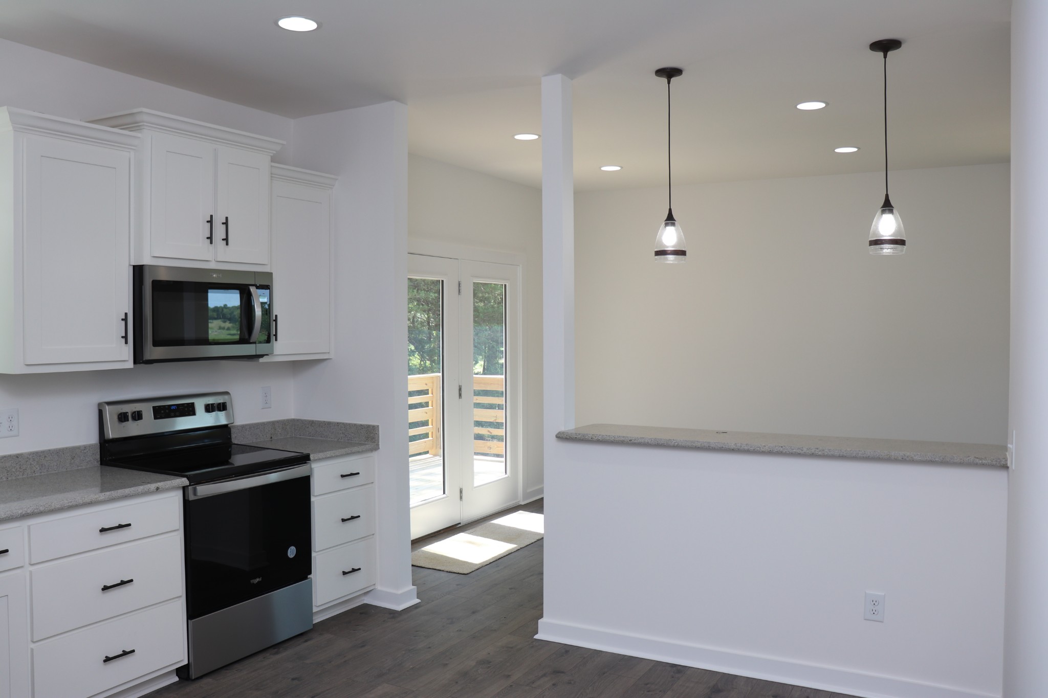 62 Shoulders Road Dixon Springs, TN 37057 - Photo 8 of 22 a kitchen with white cabinets and black appliances