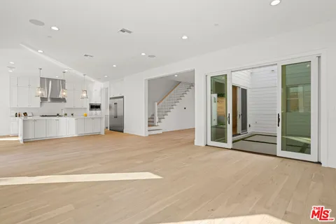 a view of a kitchen with a sink and a stove top oven