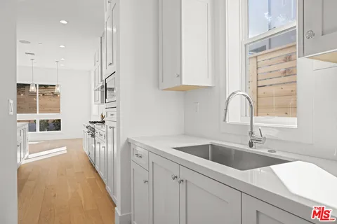 a kitchen with a sink and cabinets