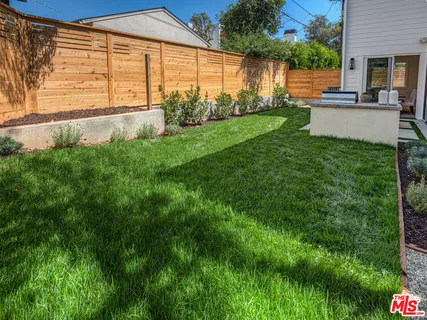 a view of a house with a backyard and a patio