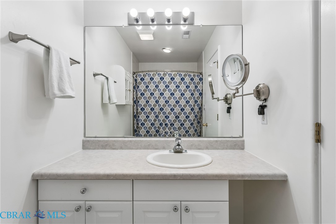 172 Sturgeon Creek Road Deltaville, VA 23043 - Photo 33 of 50 Bathroom with vanity and a shower with shower curtain