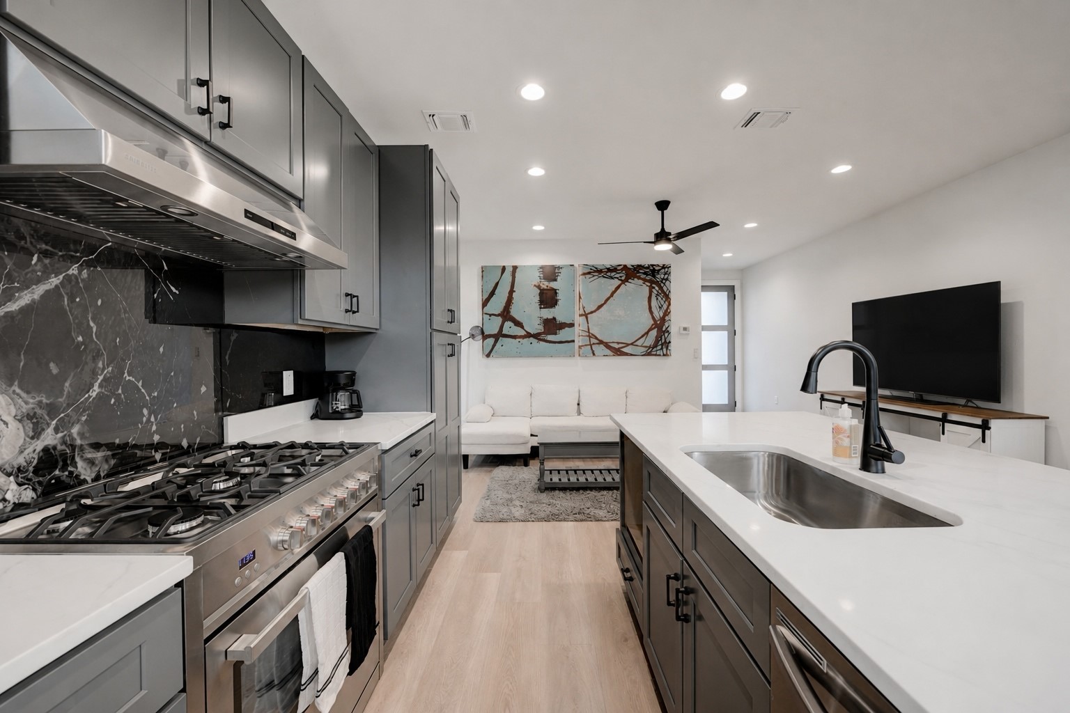 2220 Yellow Jacket Lane, Unit 1 Austin, TX 78741 - Photo 7 of 35 A sleek, open-concept kitchen flows seamlessly into a well-lit living area, perfect for entertaining.