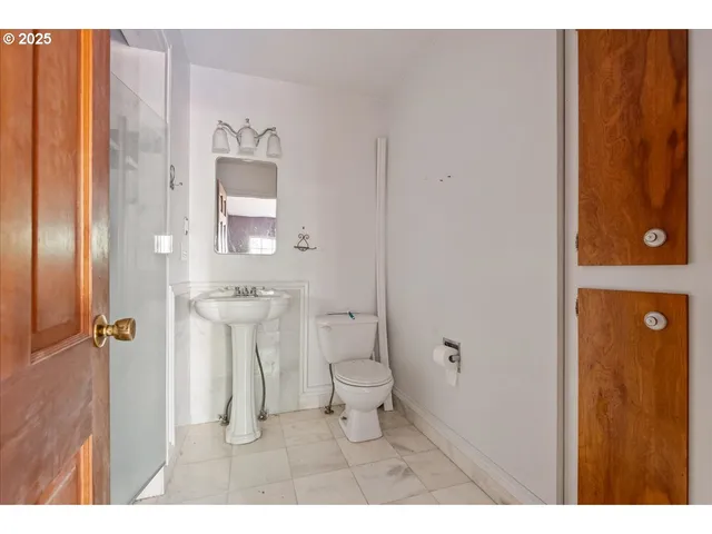a bathroom with a toilet sink and a mirror