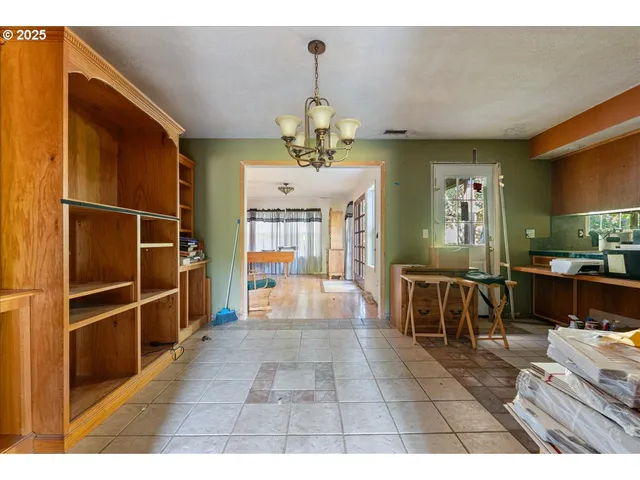 a view of dining room with furniture and a chandelier