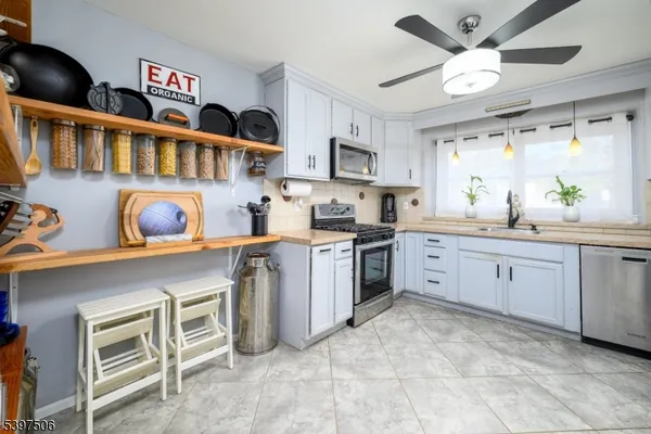 a kitchen that has cabinets a sink and a stove